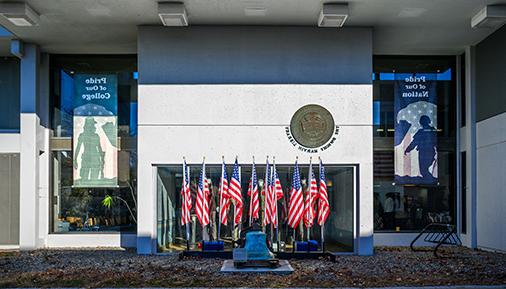 Pride of our Nation Pride of our College banners and American flags outside the Library